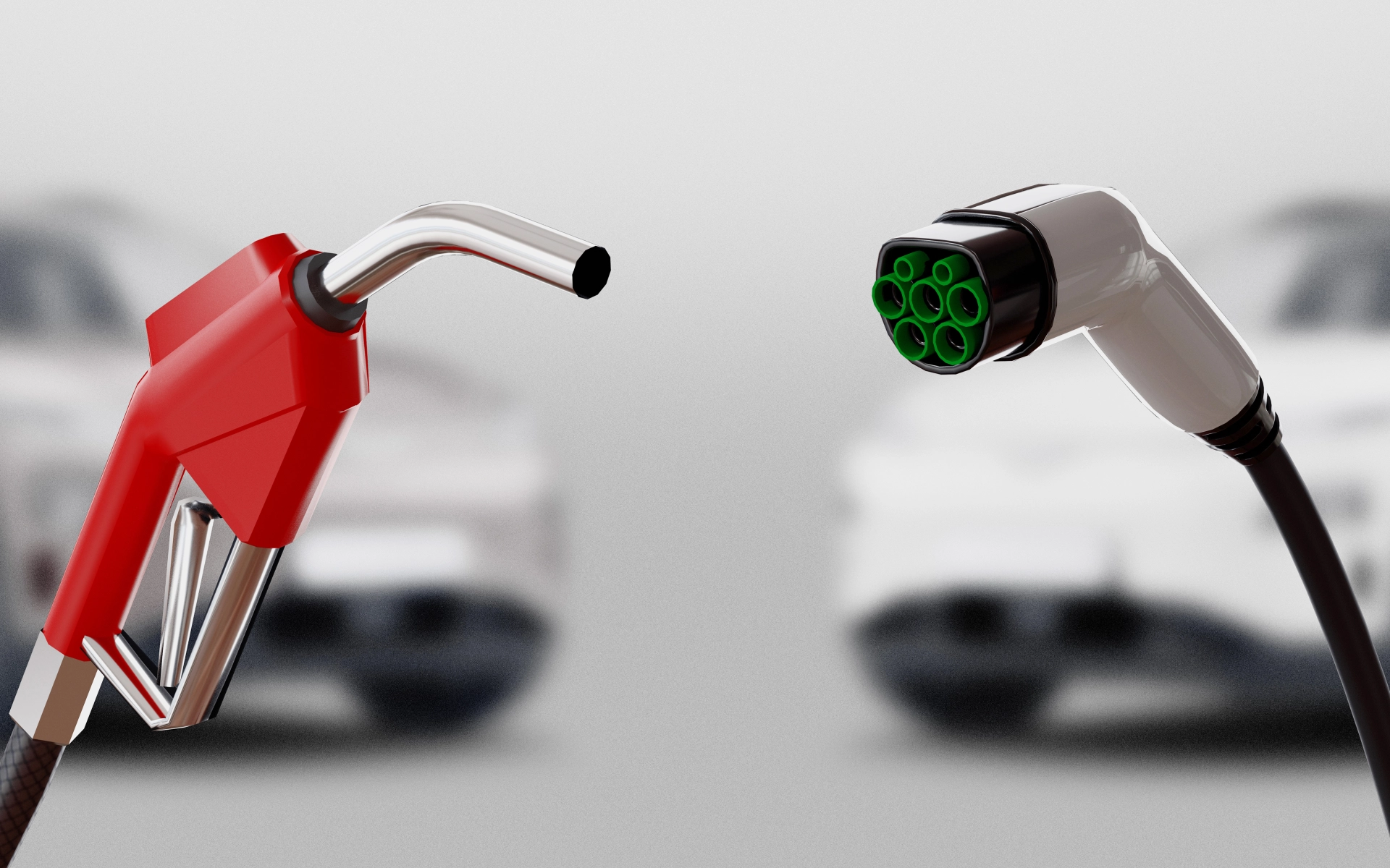Eine Zapfpistole für Benzin neben einem Ladekabel für Elektroautos.  