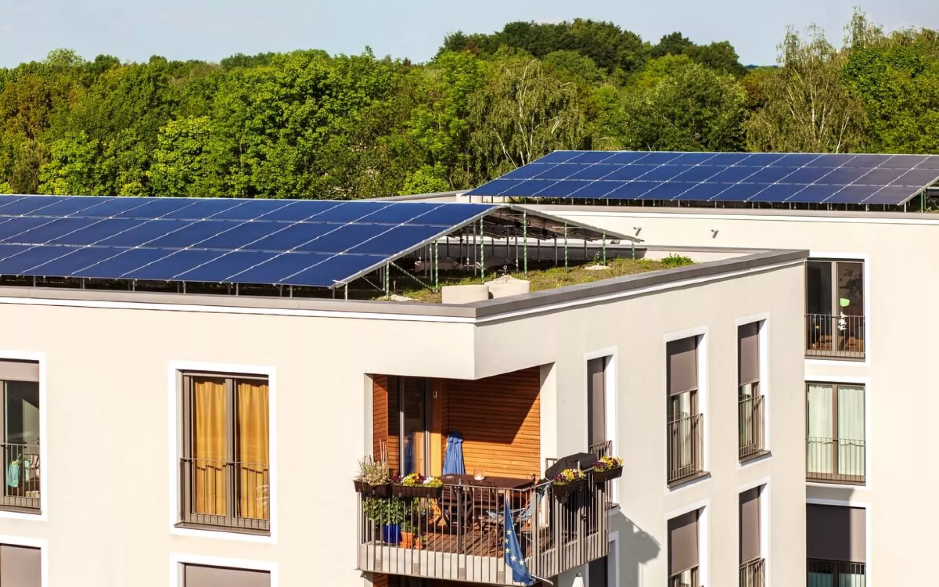Ein Mehrfamilienhaus mit Solaranlage über das komplette Dach.