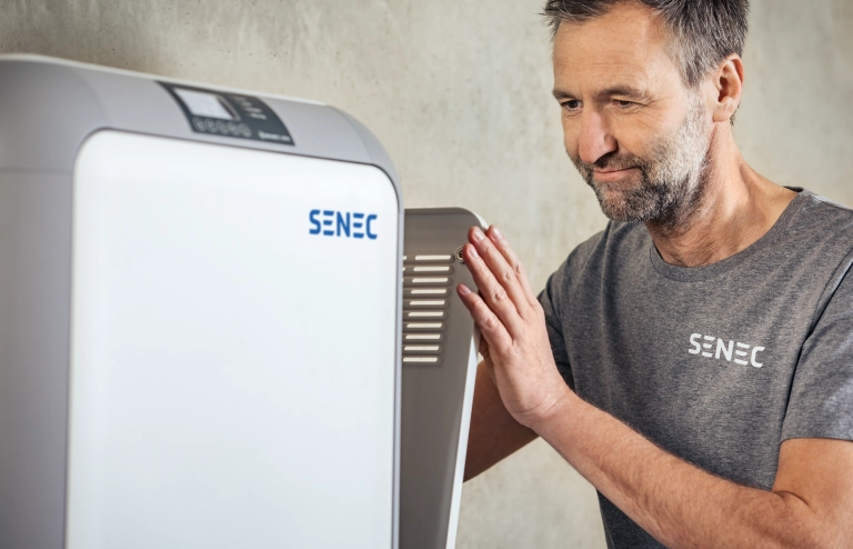 Ein Installateur rüstet einen Photovoltaik-Speicher nach.