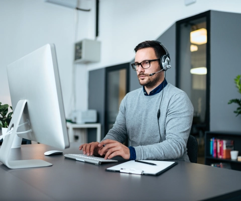 Person with headset working at the computer