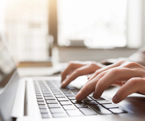 Person typing on laptop